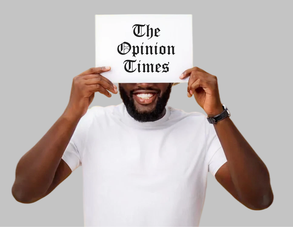 Person holding The Opinion Times